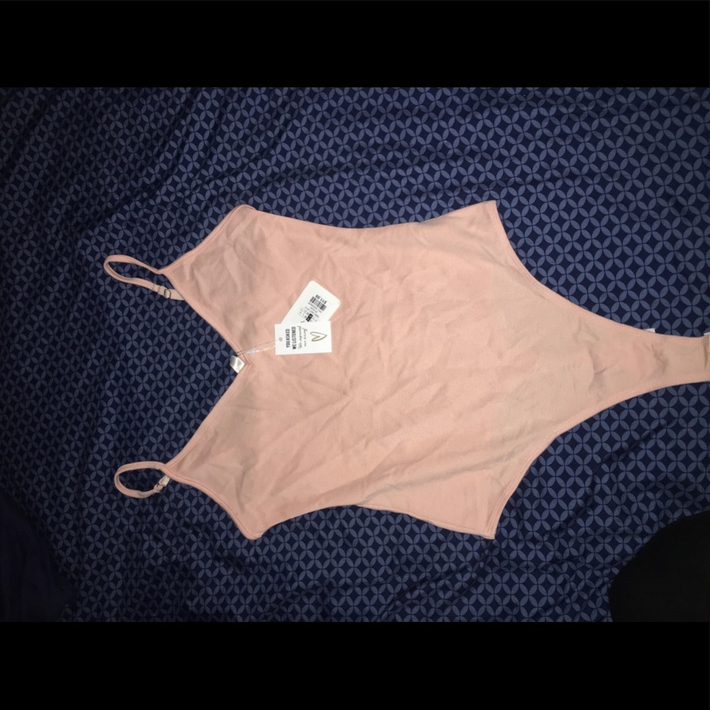 Light pink body suit size small never worn